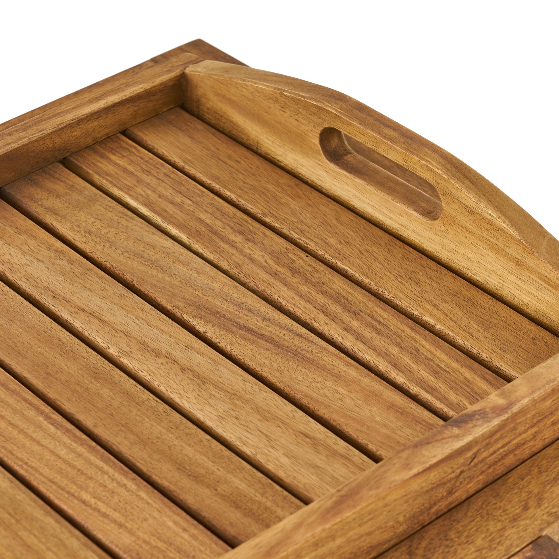 Closeup view of a rustic wooden serving tray with slatted surface and cutout handles