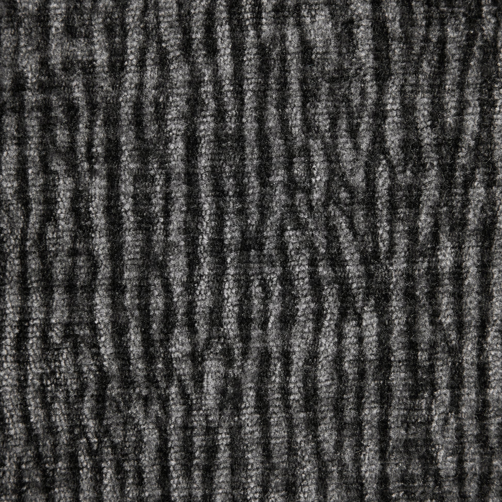 Closeup of textured dark grey carpet with ribbed pattern