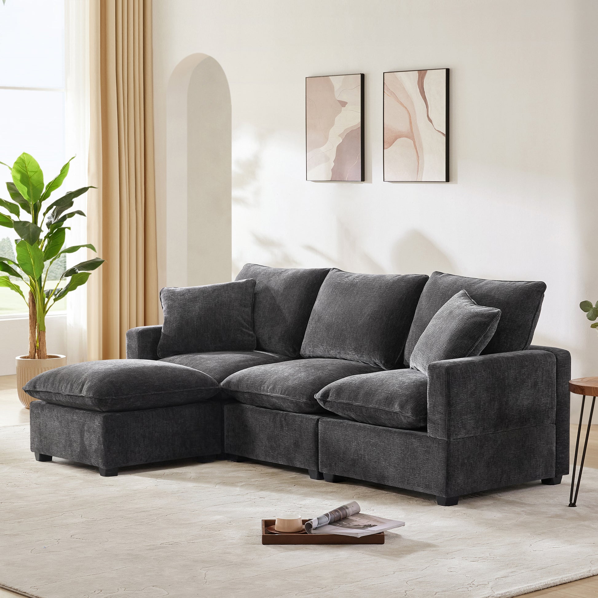 Dark gray sectional sofa with plush cushions and chaise lounge
