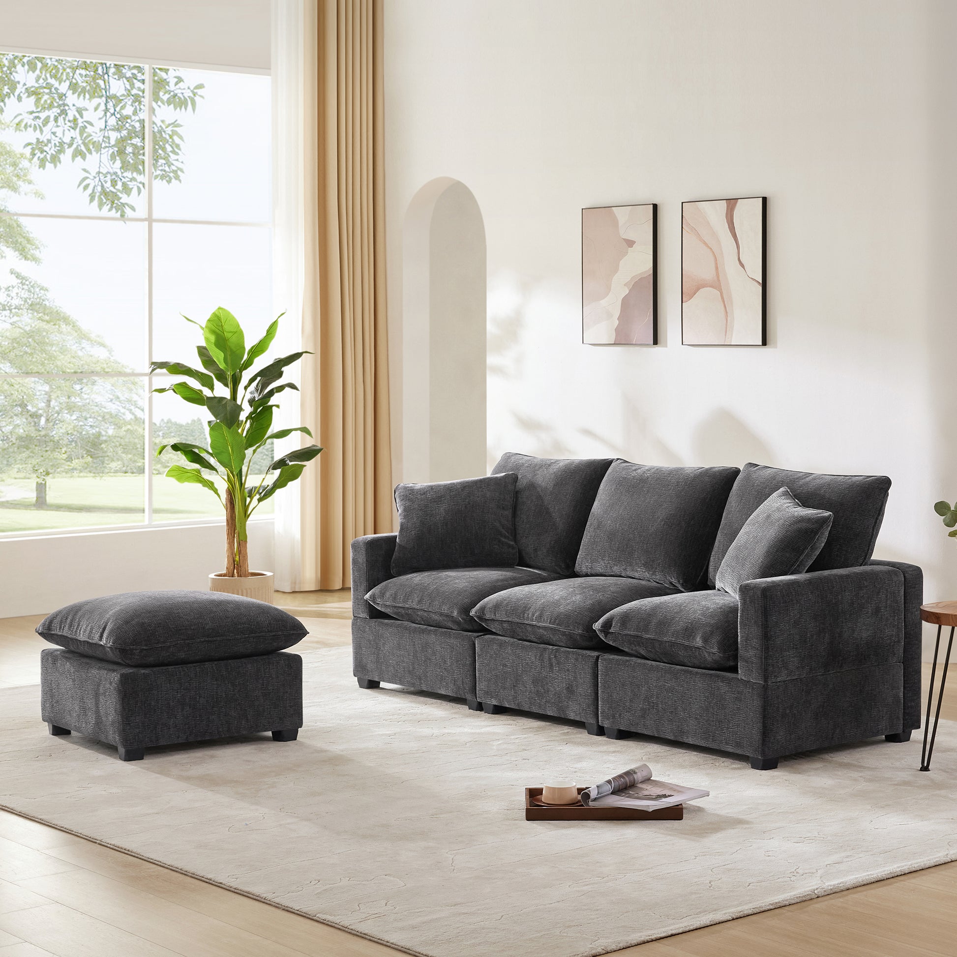 Dark gray sectional sofa with plush cushions and matching ottoman for living room comfort