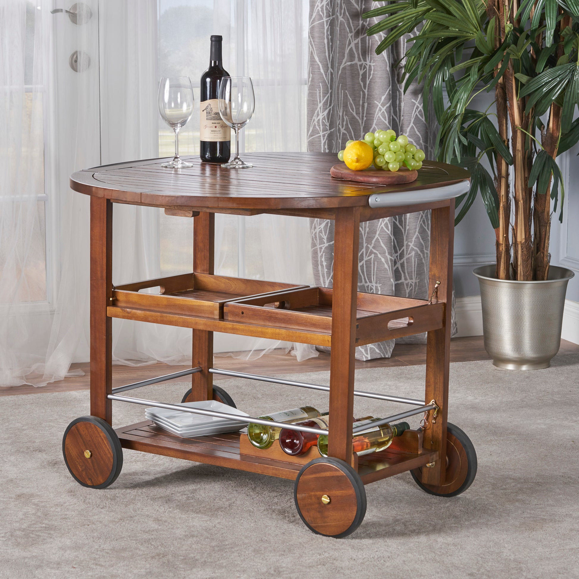 Wooden bar cart with wine bottles and glasses