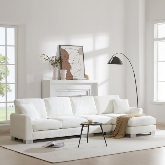 Plush white fabric sectional sofa with chaise lounge perfect for modern living rooms