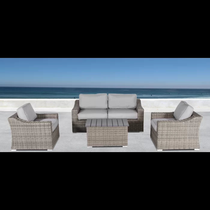 Grey wicker outdoor patio set with loveseat armchair and coffee table