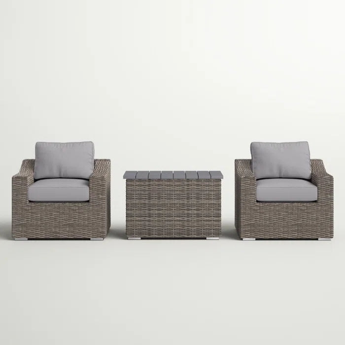 Wicker patio chair with gray cushion and matching outdoor storage bench