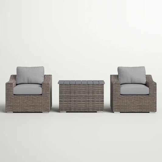 Wicker patio chair with gray cushion and matching outdoor storage bench
