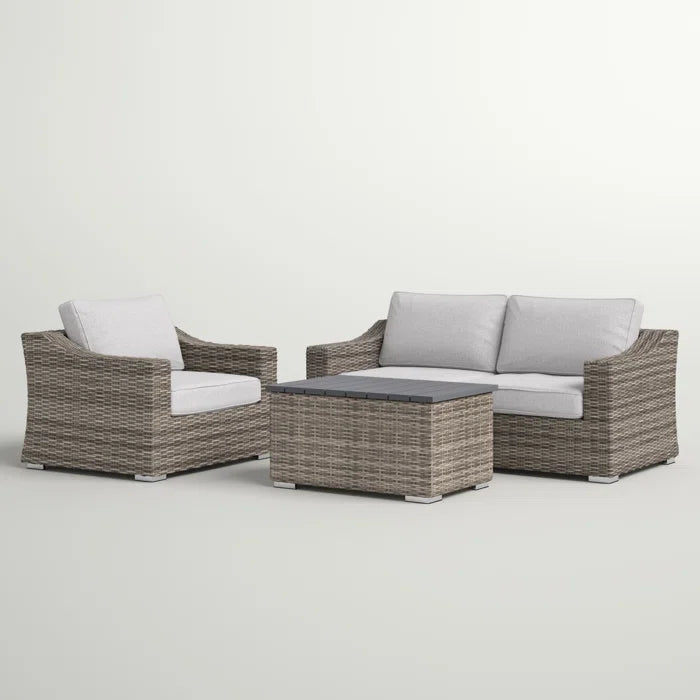 Gray wicker outdoor furniture set  chairs and a coffee table with white cushions