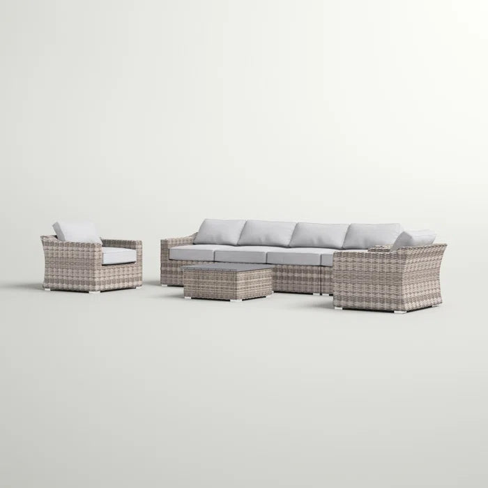 Gray wicker outdoor sectional sofa set with plush cushions and a coffee table