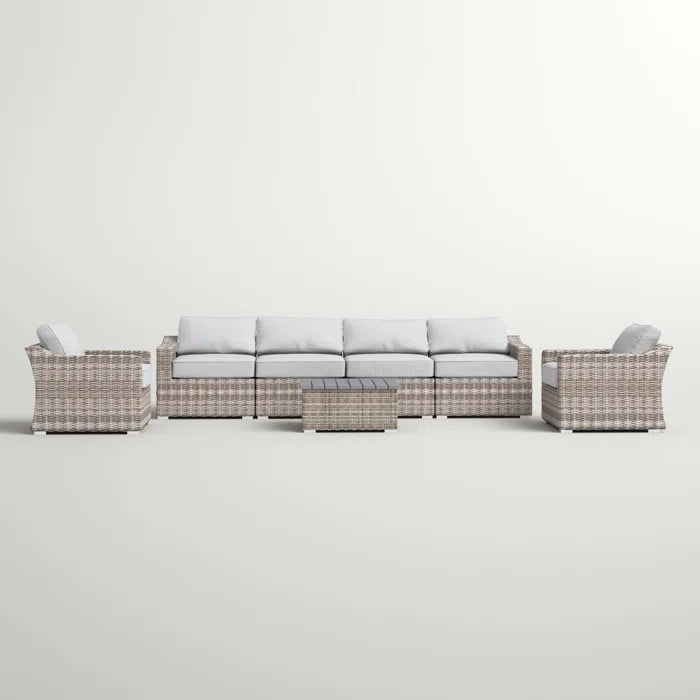Rattan outdoor furniture set with gray cushions includes sectional sofa and coffee table