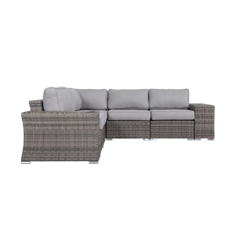 Grey wicker Lshaped outdoor sectional sofa with plush light grey cushions