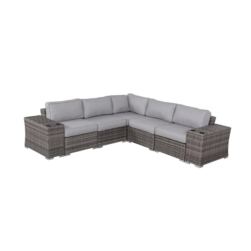 Gray wicker sectional sofa with plush light gray cushions and builtin cup holders