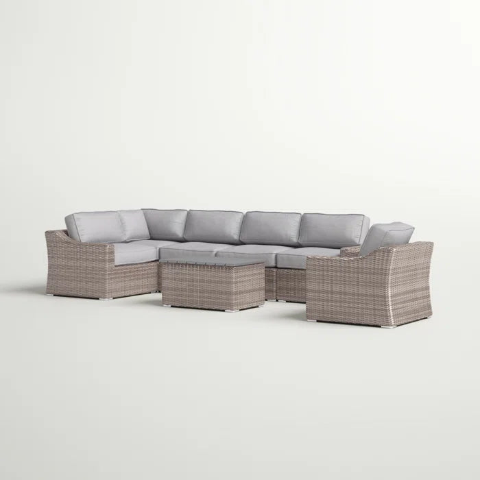 Wicker sectional sofa with light gray cushions and a matching coffee table