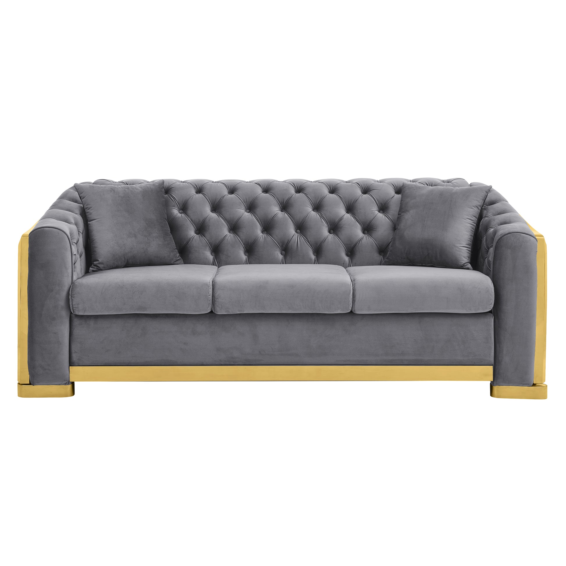 Grey velvet tufted sofa with gold accents and two accent pillows
