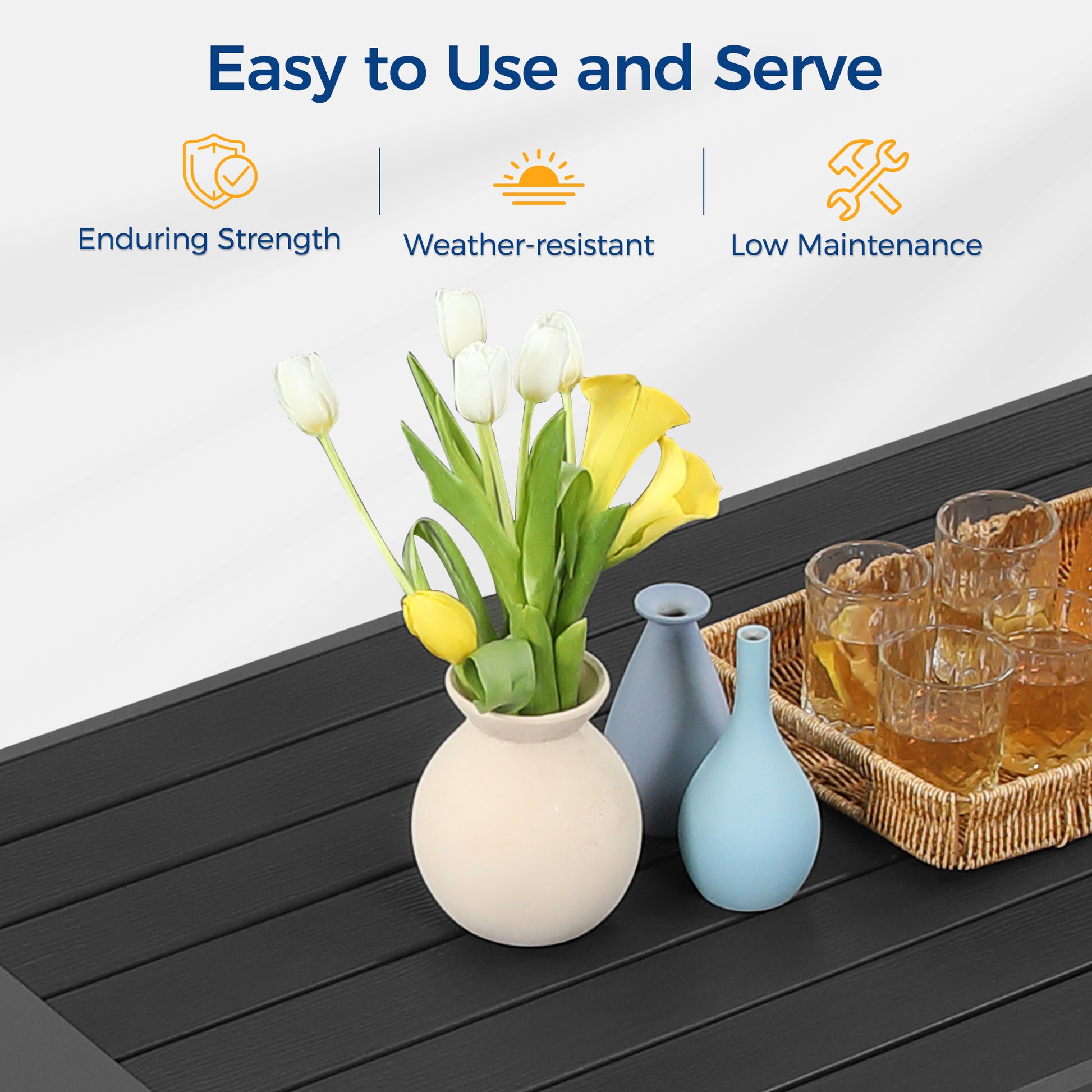 Black slatted patio table surface with floral arrangements and drinks for outdoor entertaining