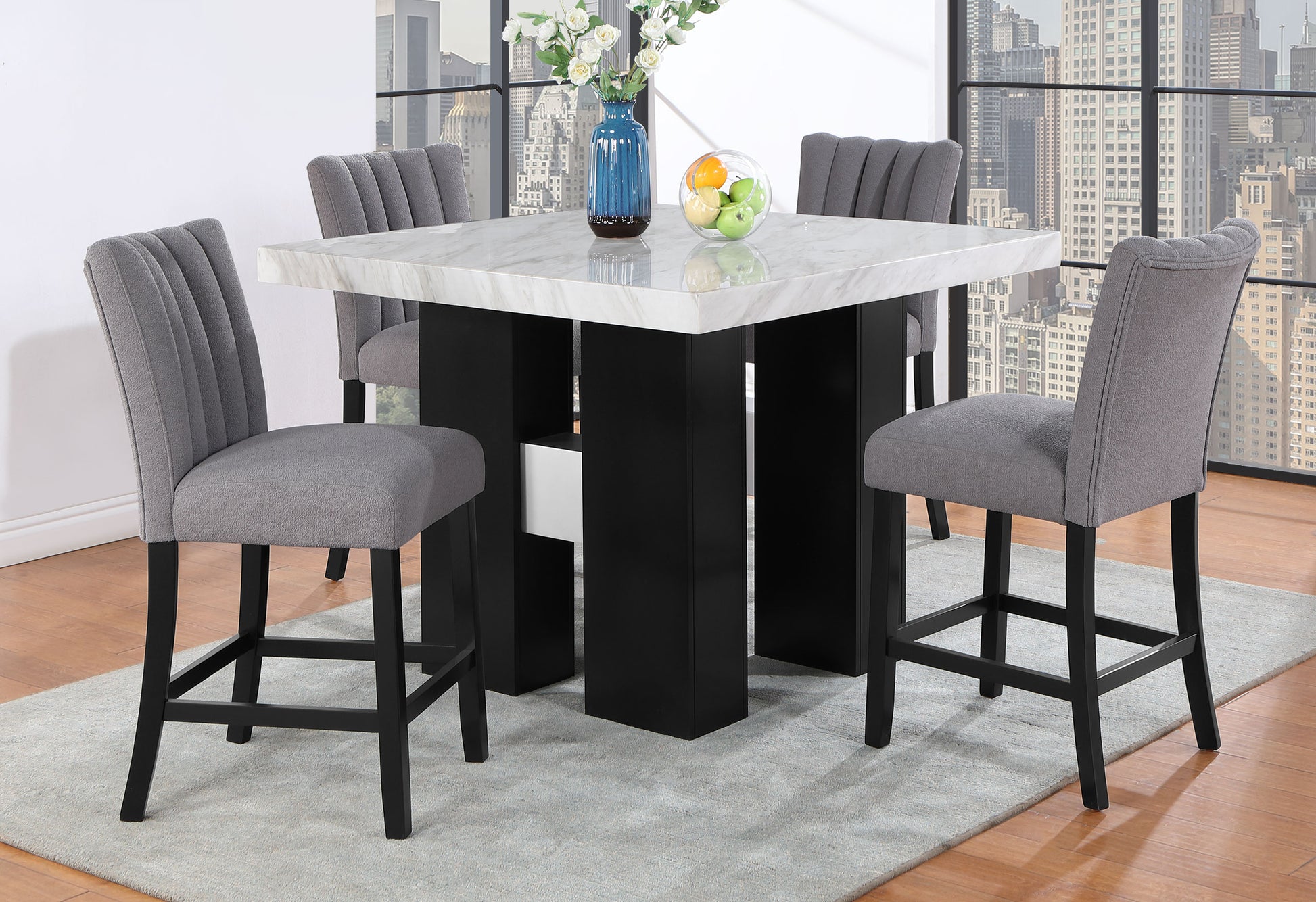 Square faux marble top dining table with black pedestal base and grey upholstered bar stools