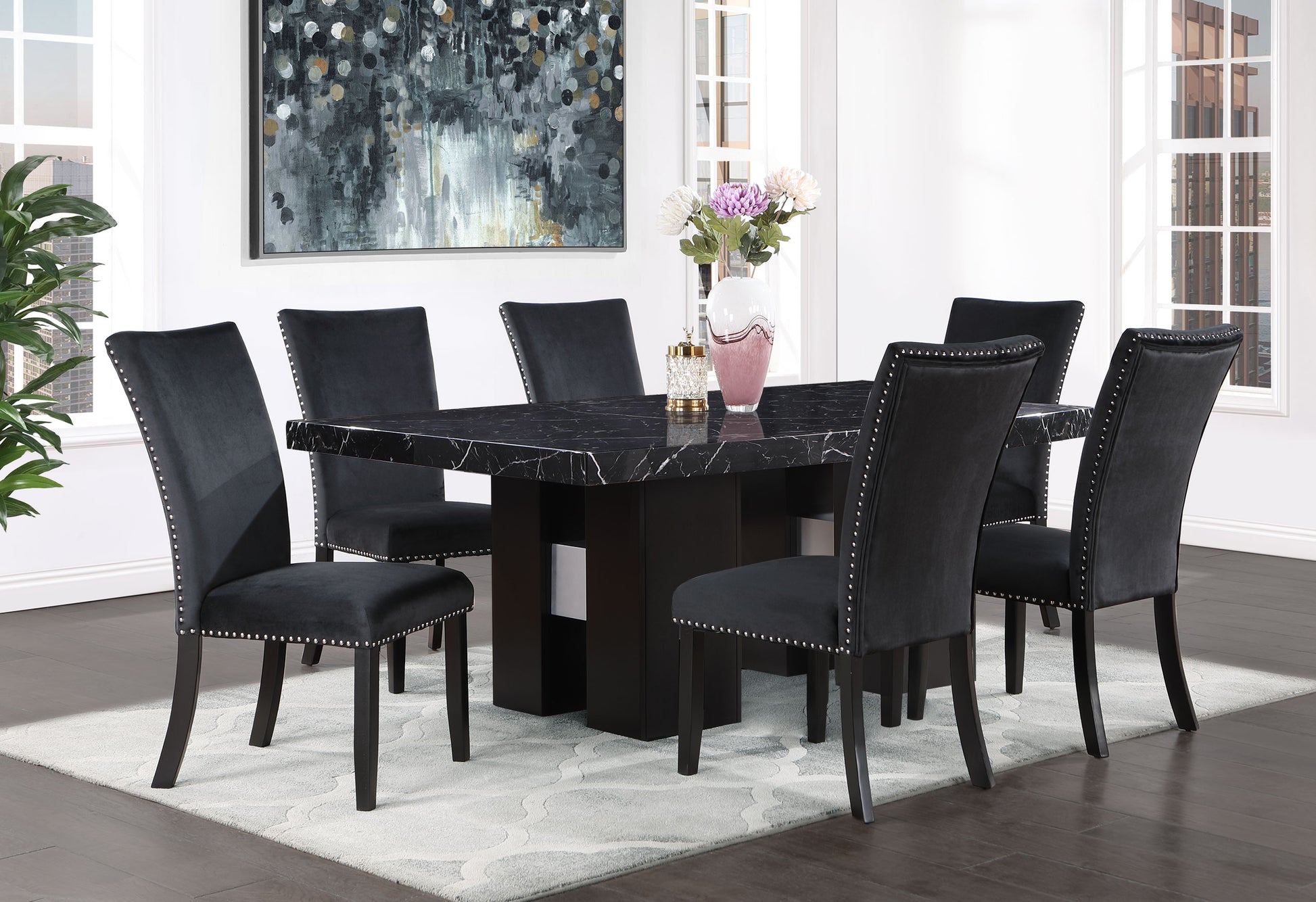 Black marble dining table with six upholstered studded chairs for elegant dining