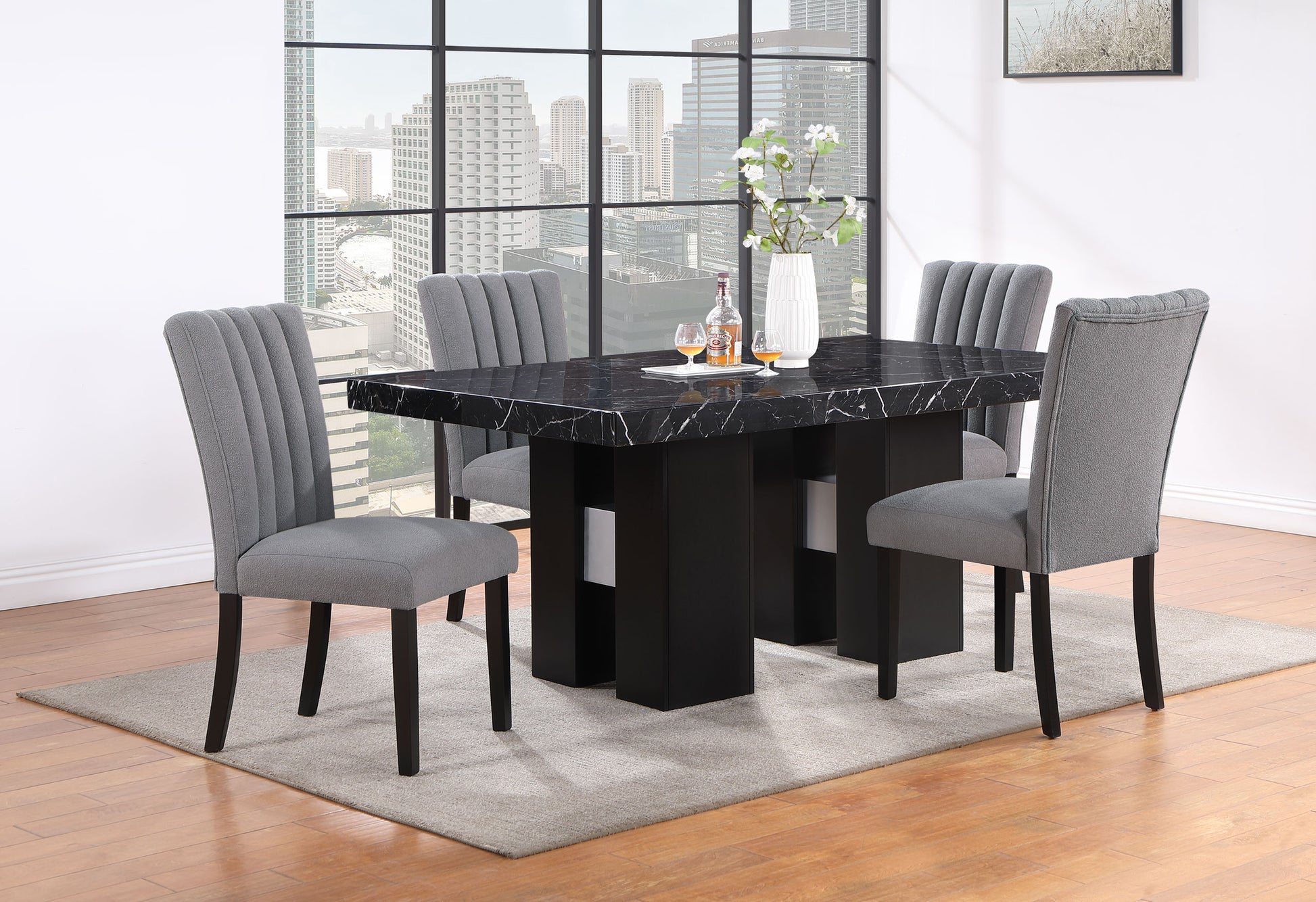 Modern black marble dining table set with four grey upholstered chairs