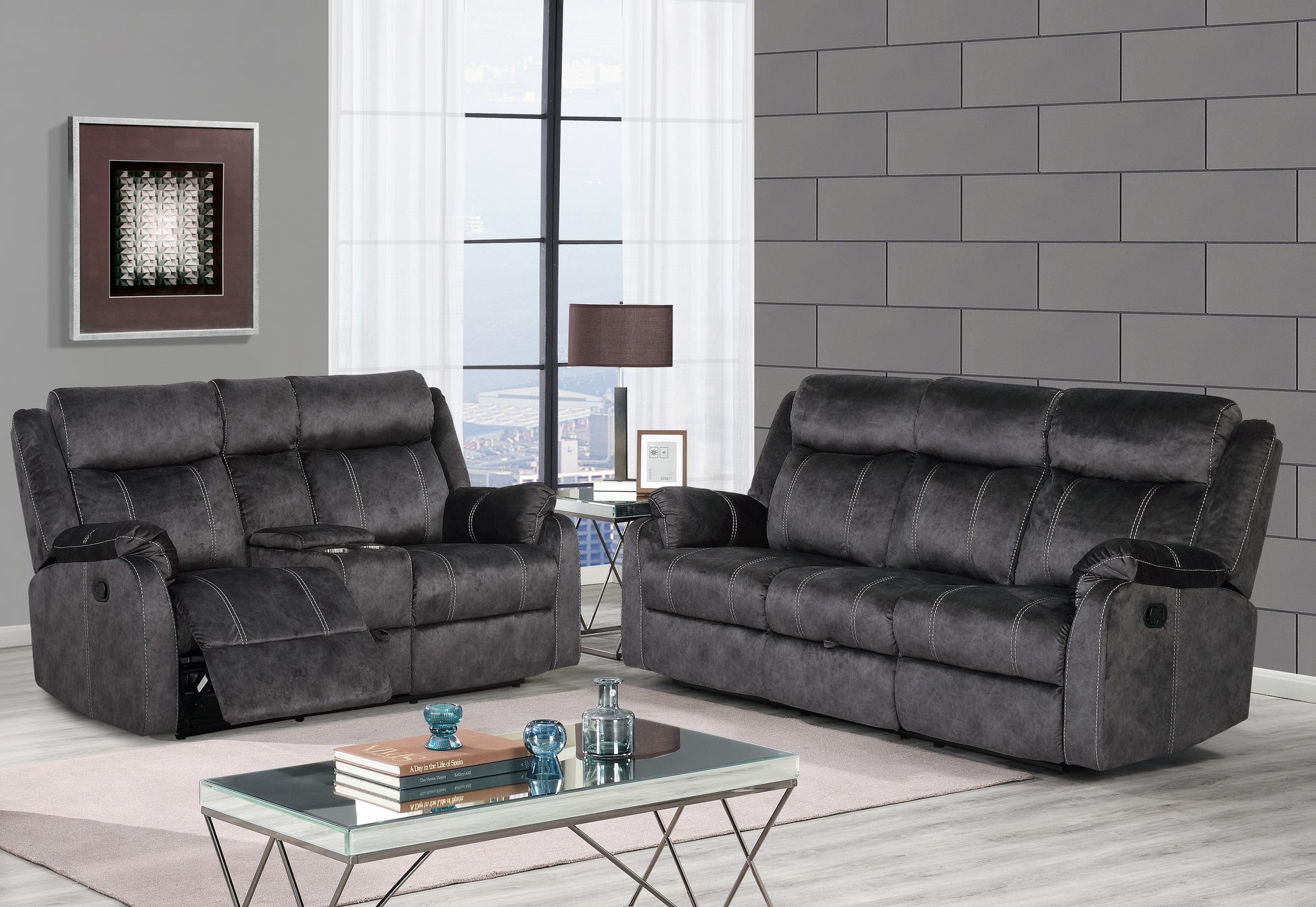 Dark gray upholstered recliner sofa with white stitching plush cushions and wide arms