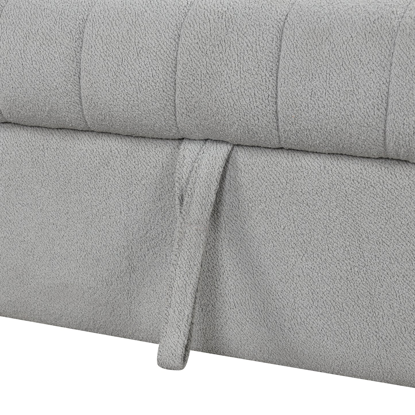 Closeup of textured grey fabric on a storage ottoman with a pull tab