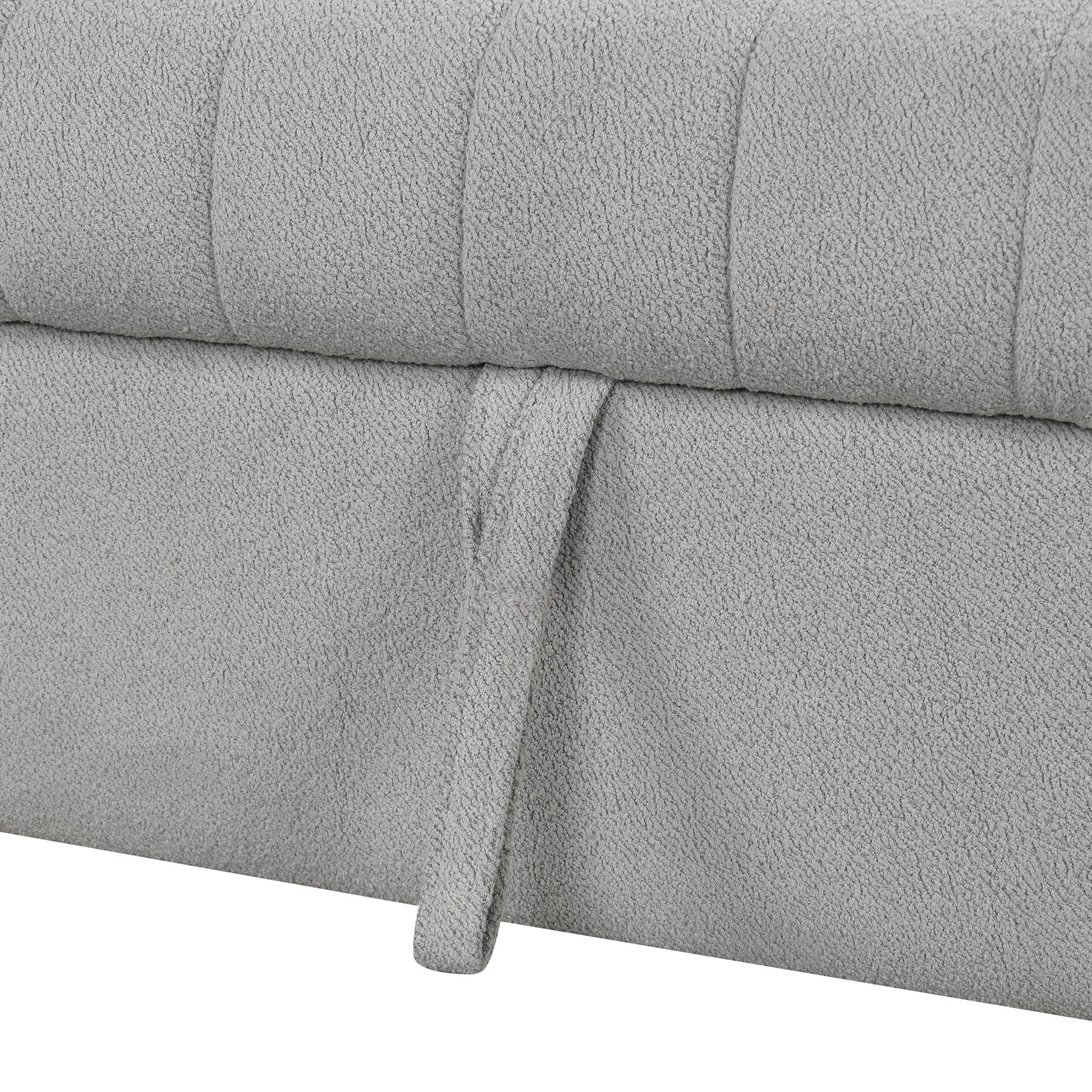 Closeup of textured grey fabric on a storage ottoman with a pull tab