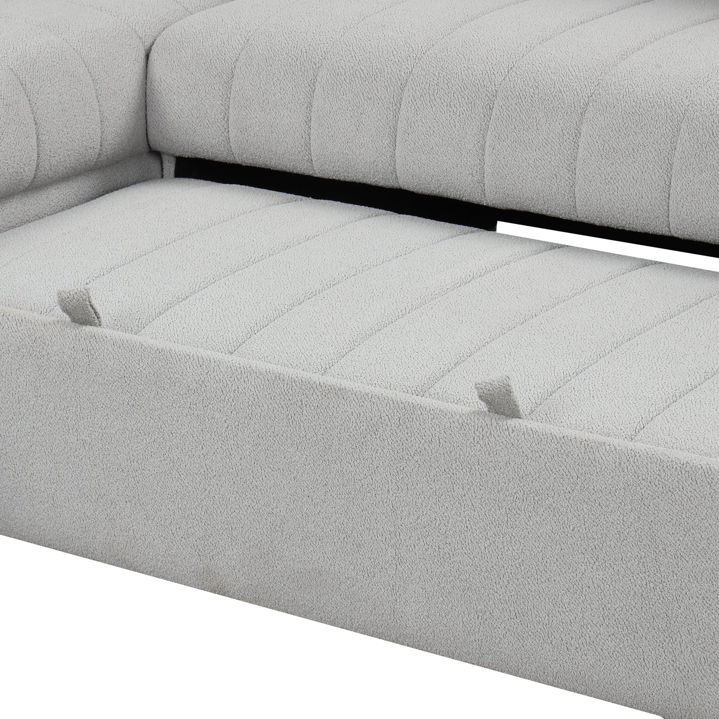 Closeup of a light grey textured fabric sofa with channel tufting