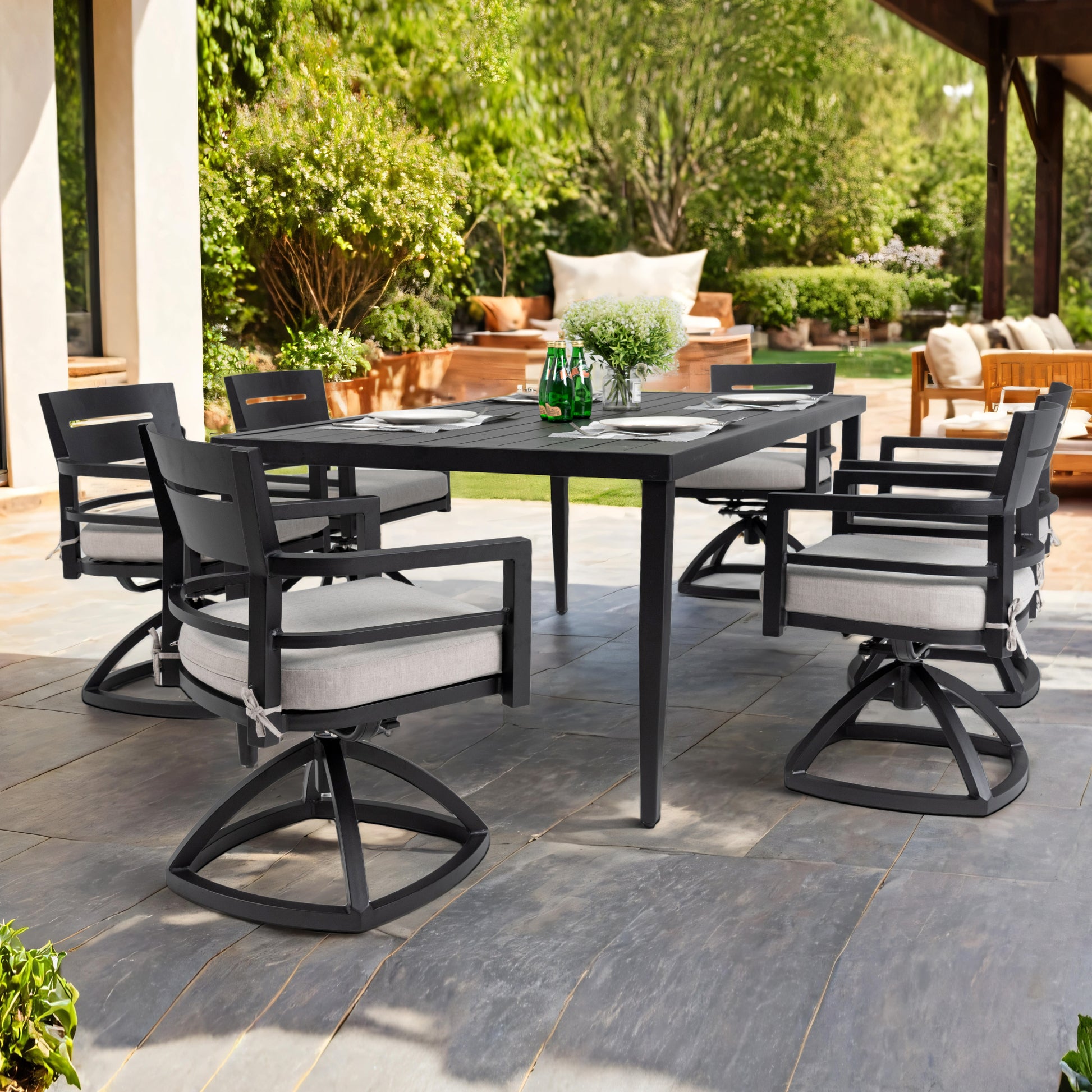 Black metal dining set with swivel chairs featuring grey cushions for outdoor entertaining