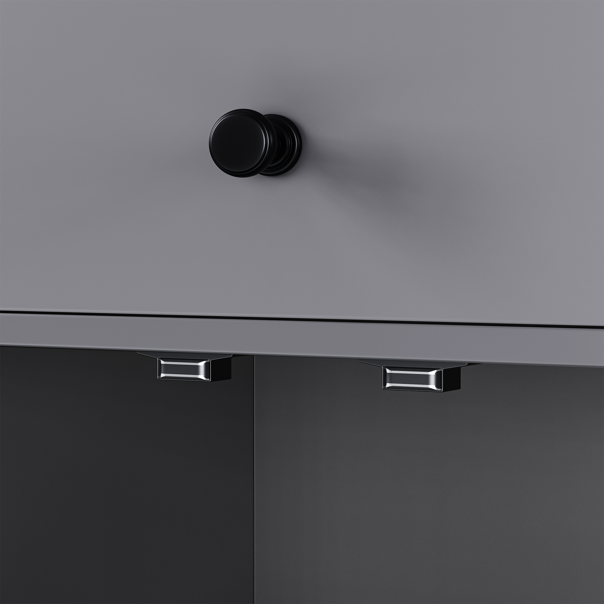Closeup of a gray cabinet with a black round knob and silver drawer pulls