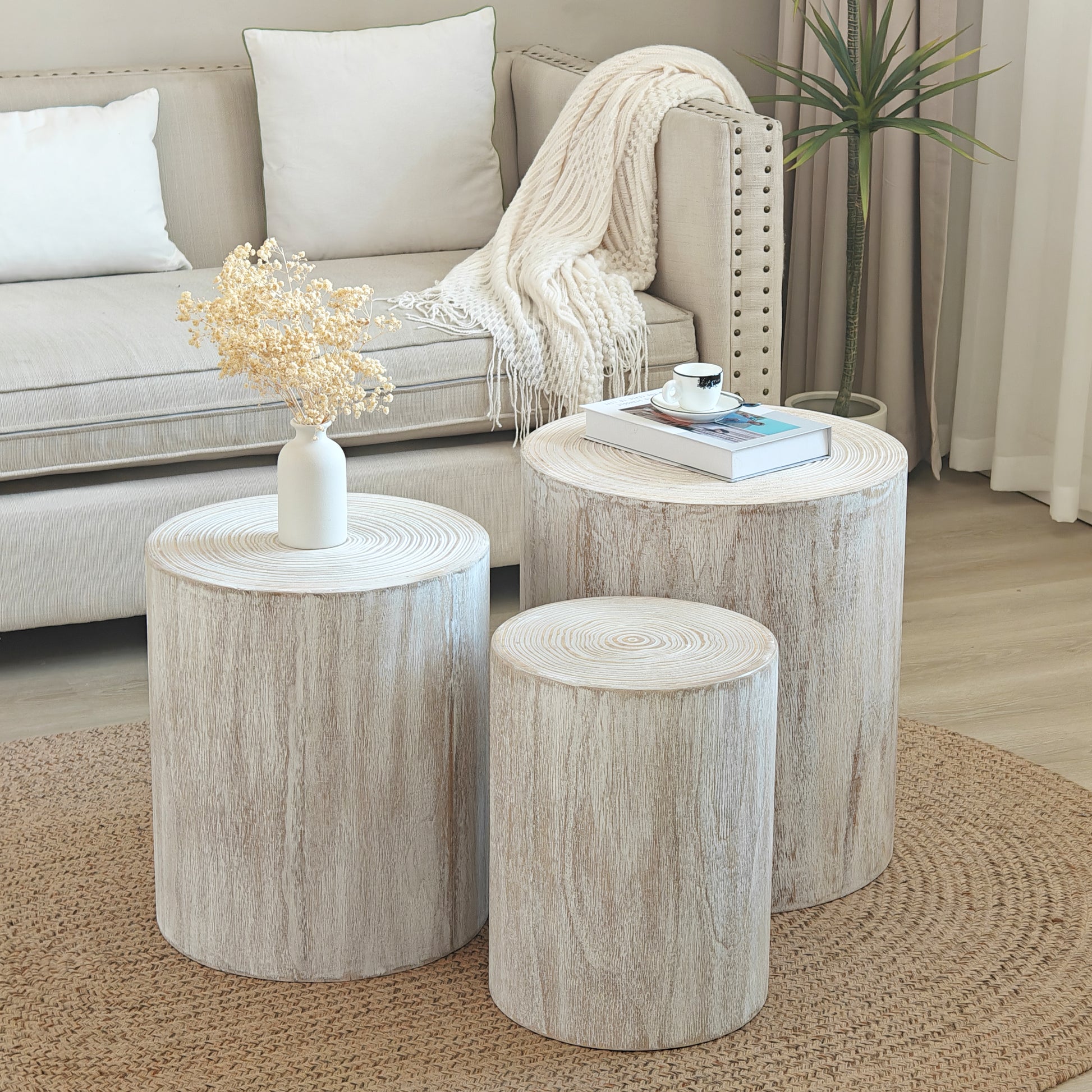 Three rustic white wood stump side tables with natural wood grain texture