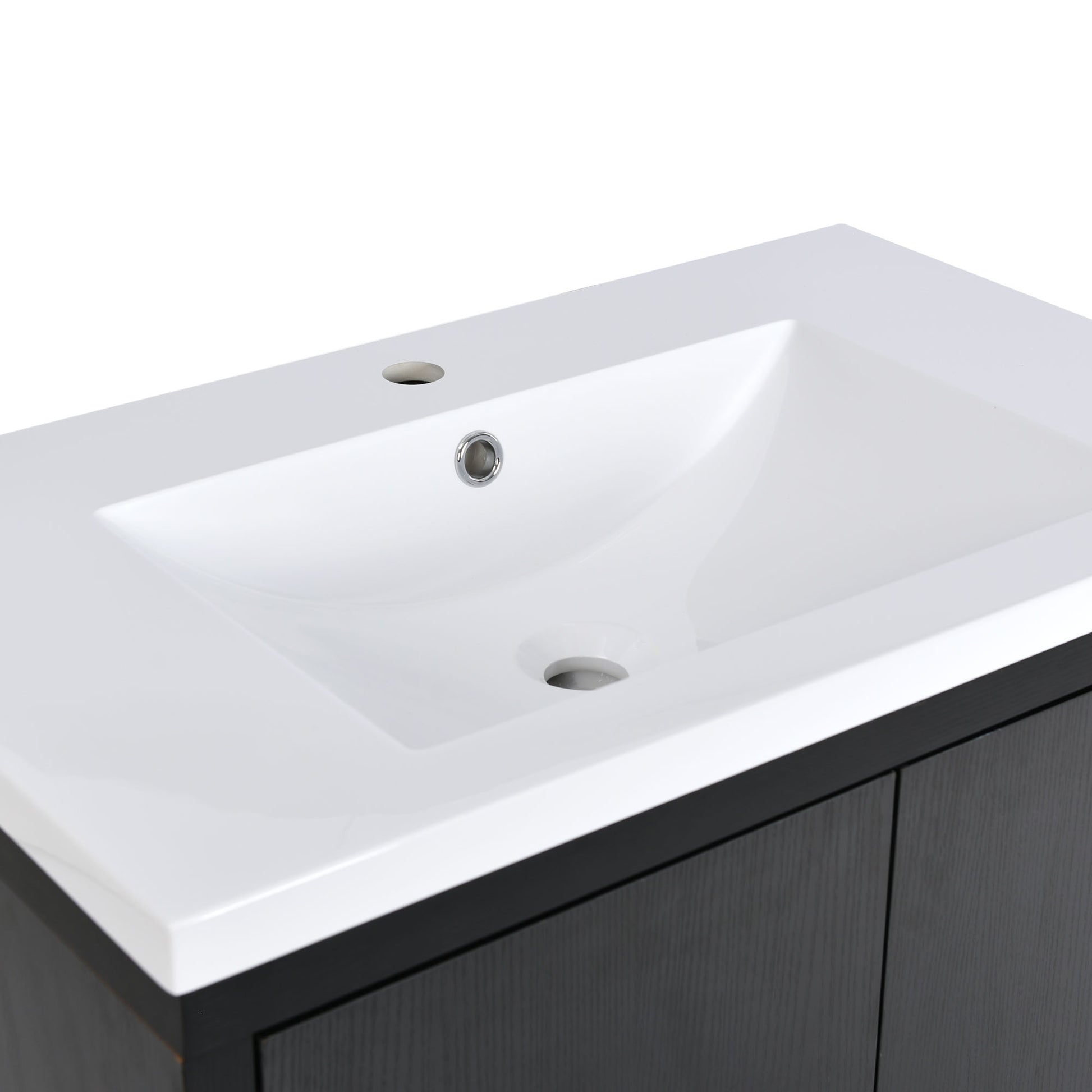 White ceramic undermount sink with chrome faucet hole on a dark wood vanity
