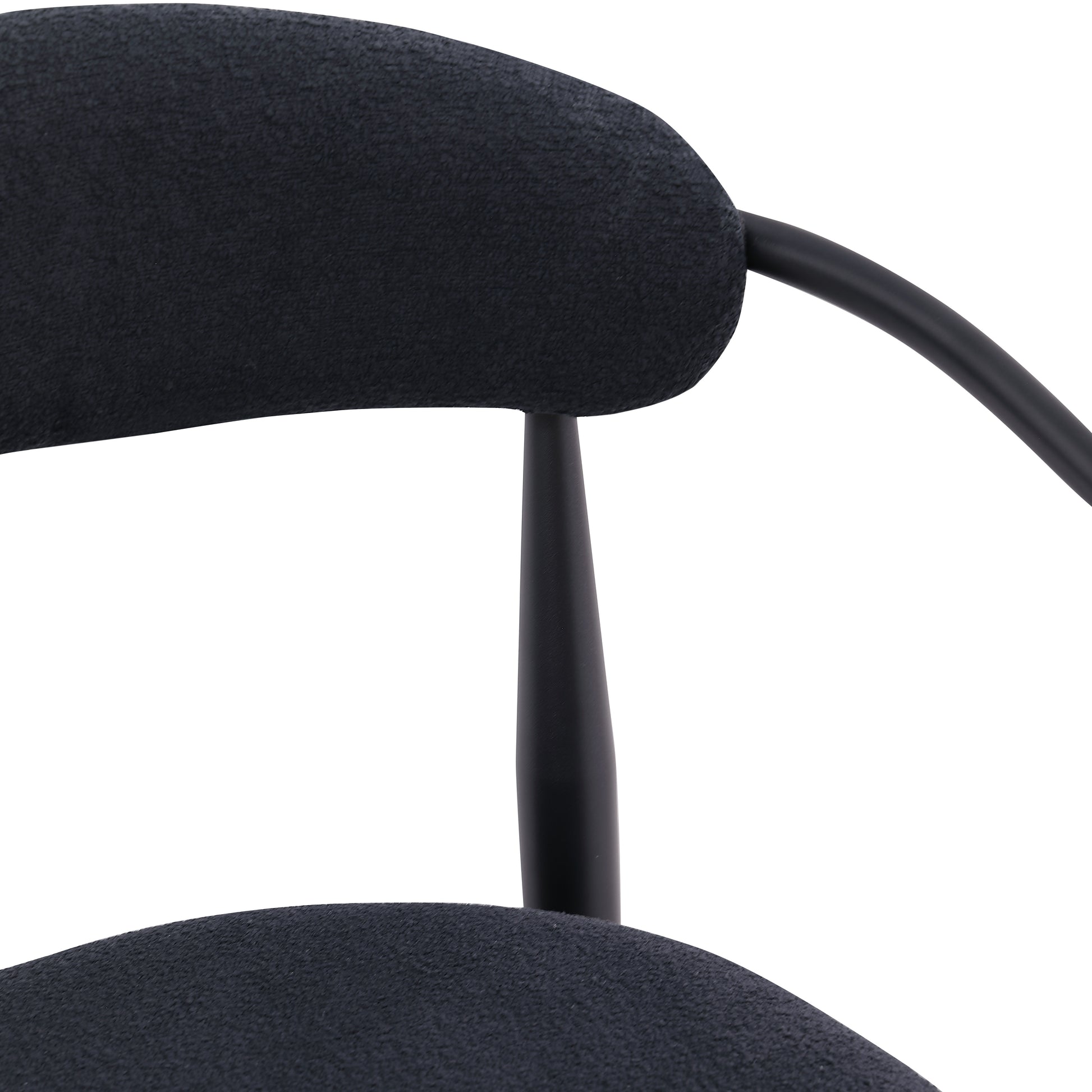 Black upholstered midcentury modern chair detail with curved back and tapered leg