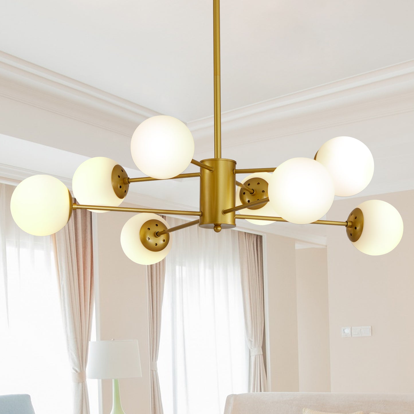 Modern gold chandelier with frosted glass globe lights illuminating a living room