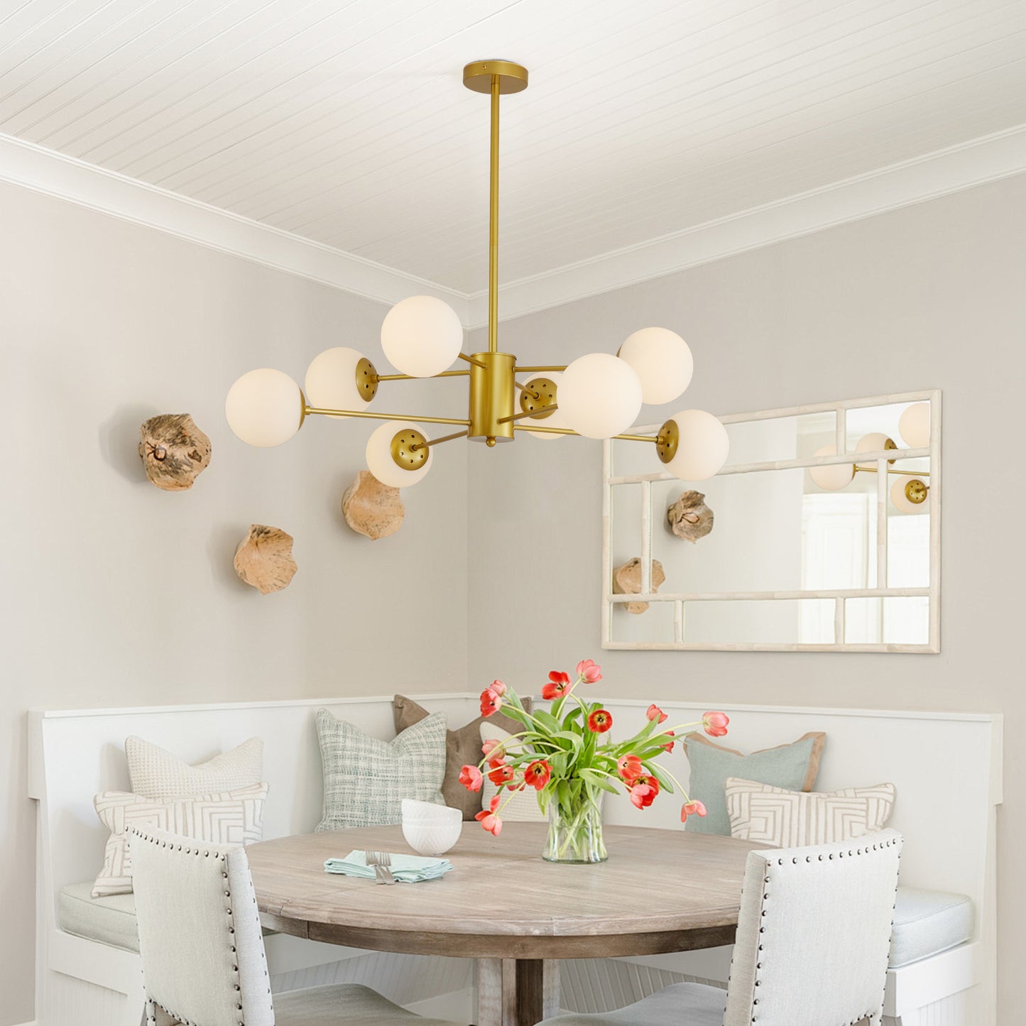 Modern brass sputnik chandelier with frosted globe lights casting warm ambient light