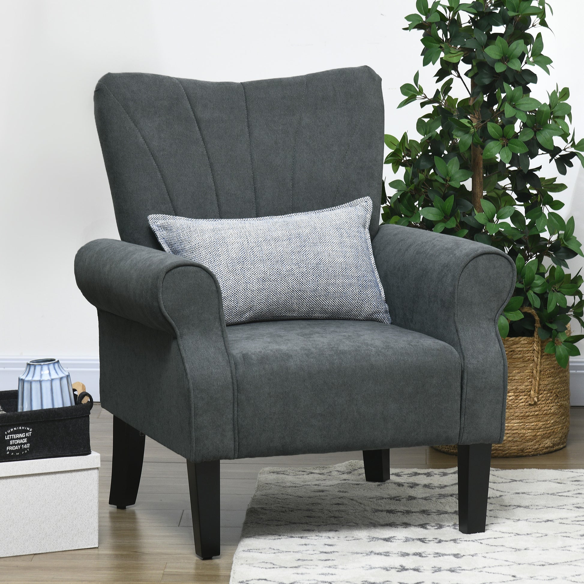 Dark grey accent chair with channel tufting and rolled arms perfect for a living room