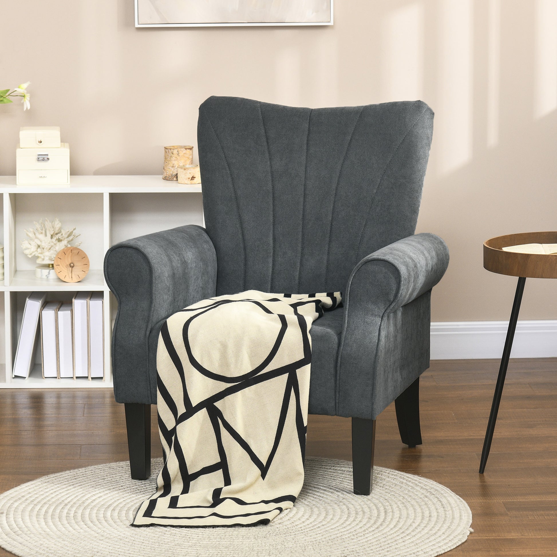 Modern charcoal gray accent chair with a channeltufted back and rolled arms