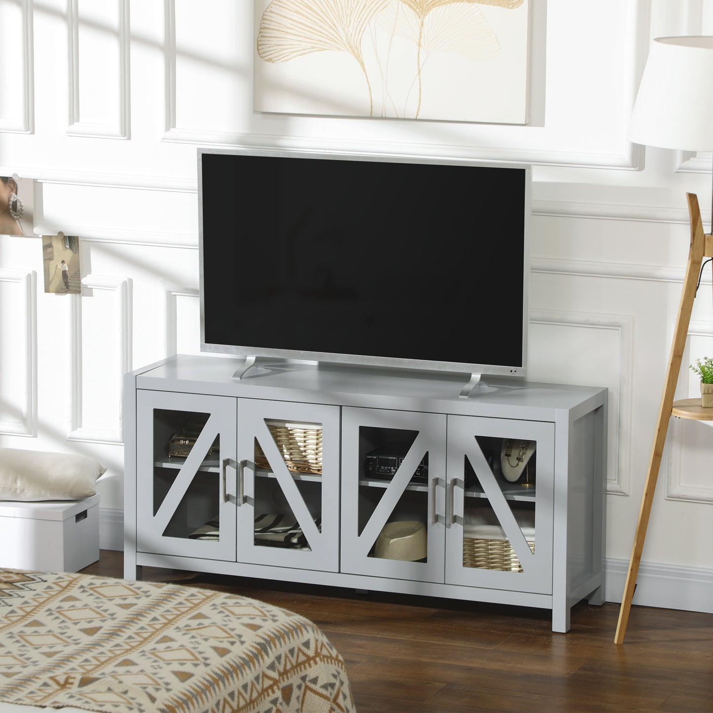Gray media console with glasspaneled doors and storage for electronics and decor