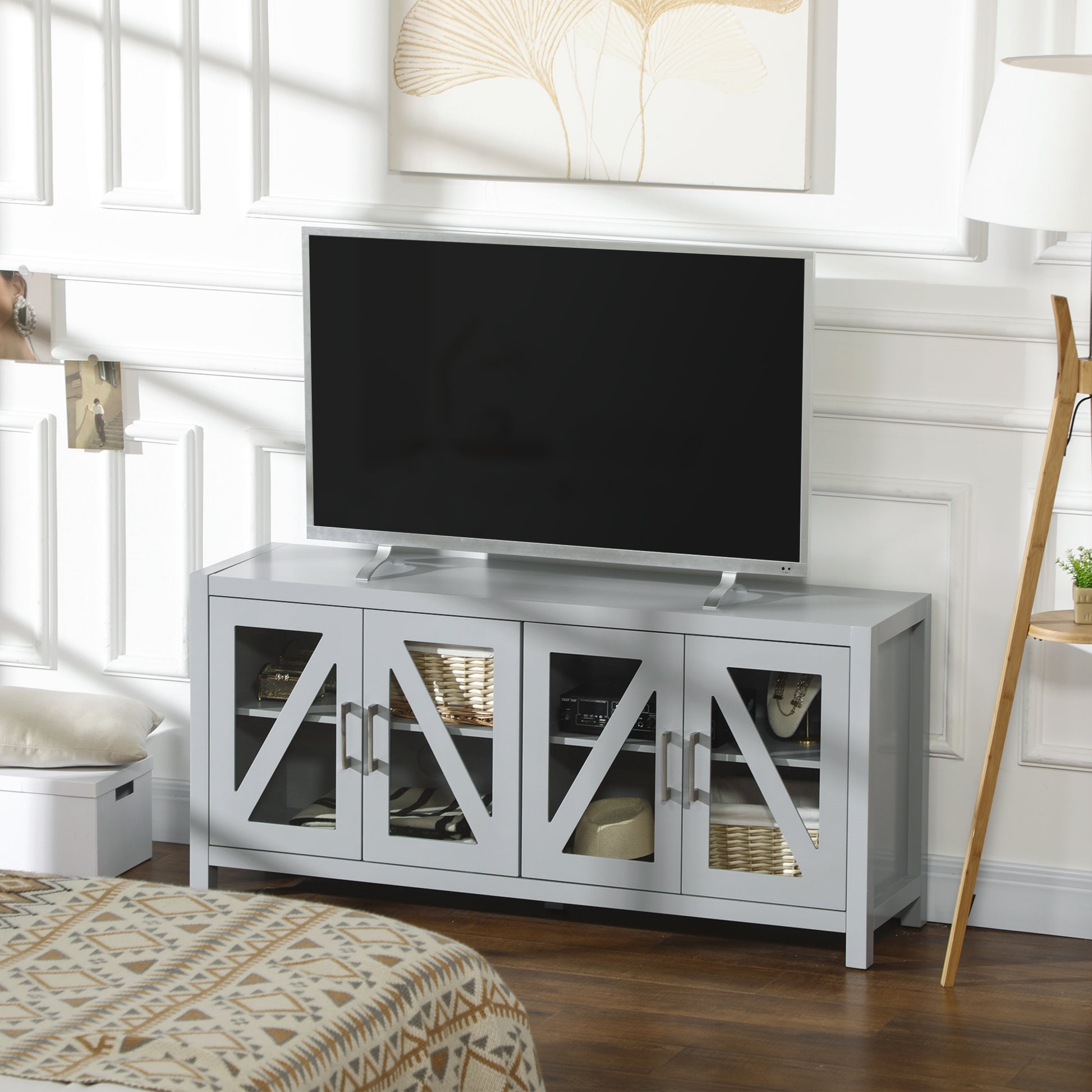 Gray media console with glasspaneled doors and storage for electronics and decor