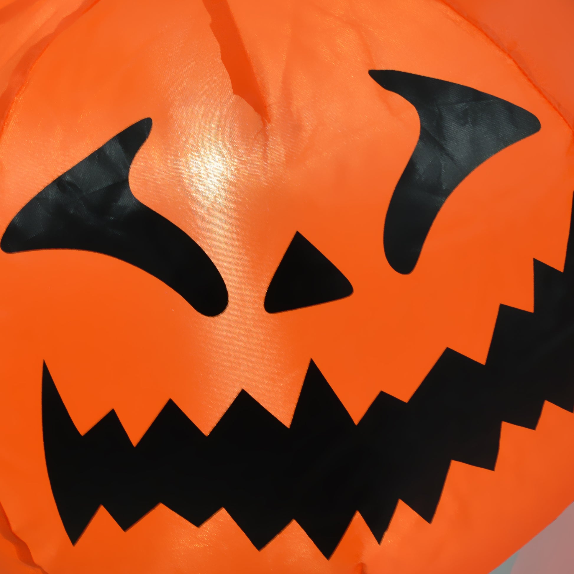 Orange inflatable Halloween decoration with a classic jackolantern face