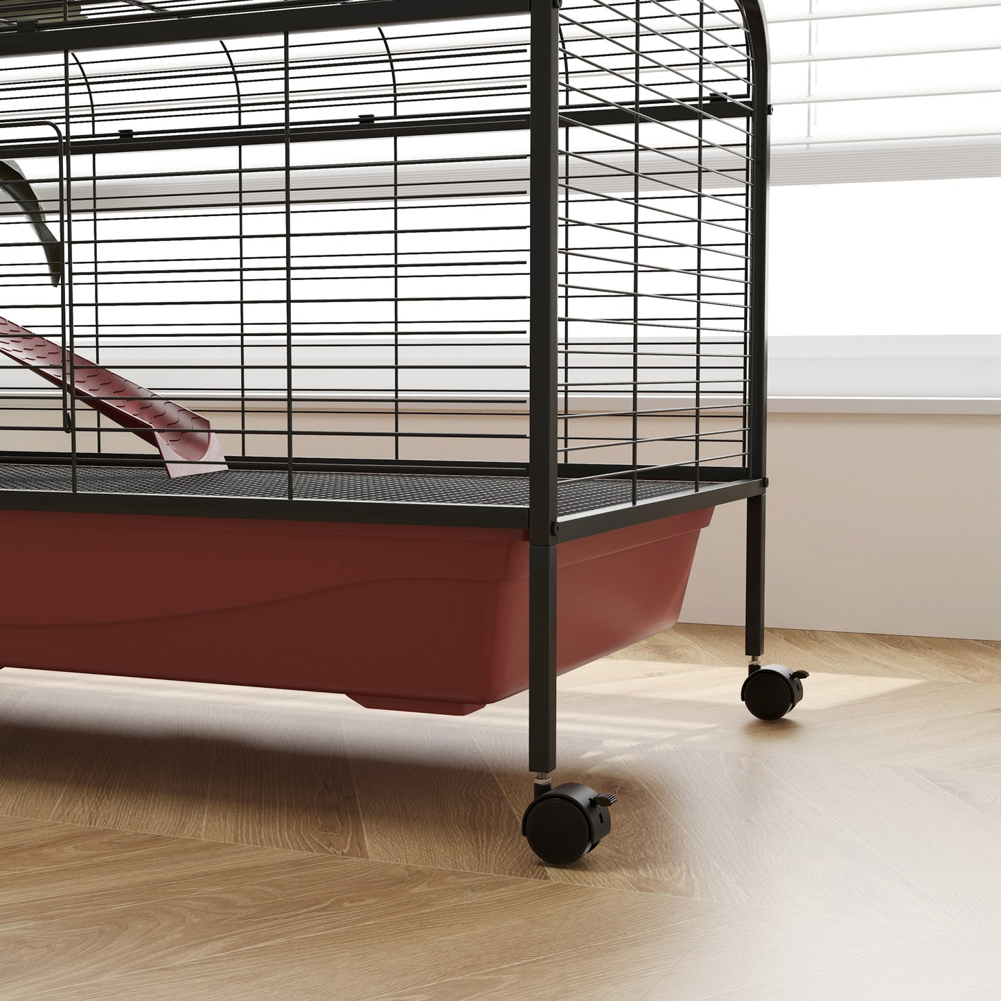 Black wire pet cage with red plastic base and red slide