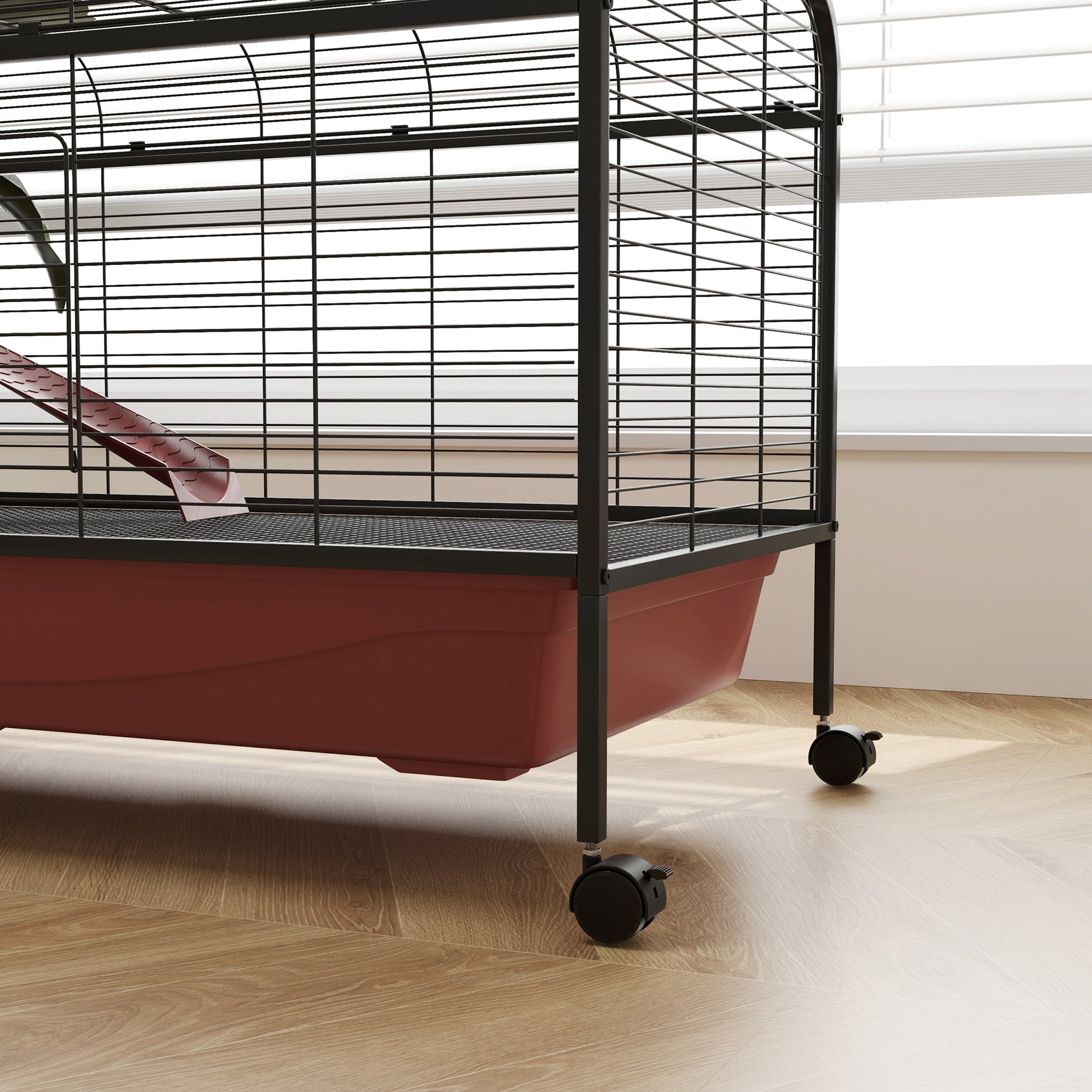 Black wire pet cage with red plastic base and red slide