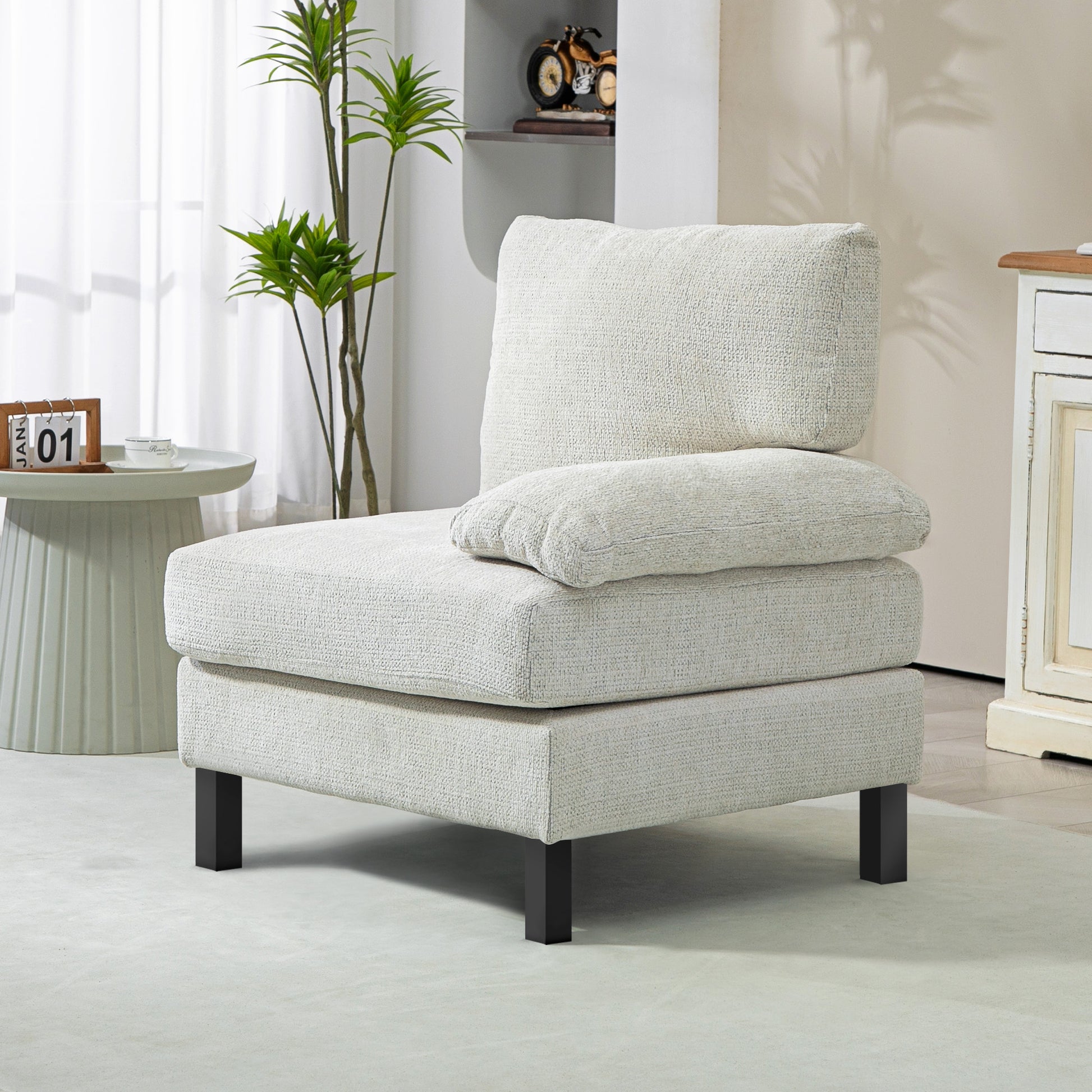 Textured cream armchair with plush cushions and dark wood legs a cozy accent chair