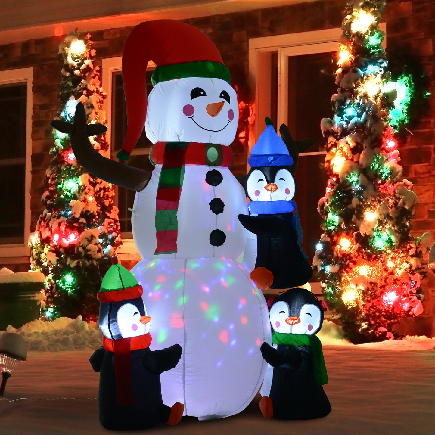 Large inflatable snowman with three penguins featuring festive lights and Christmas scarf for outdoor decor