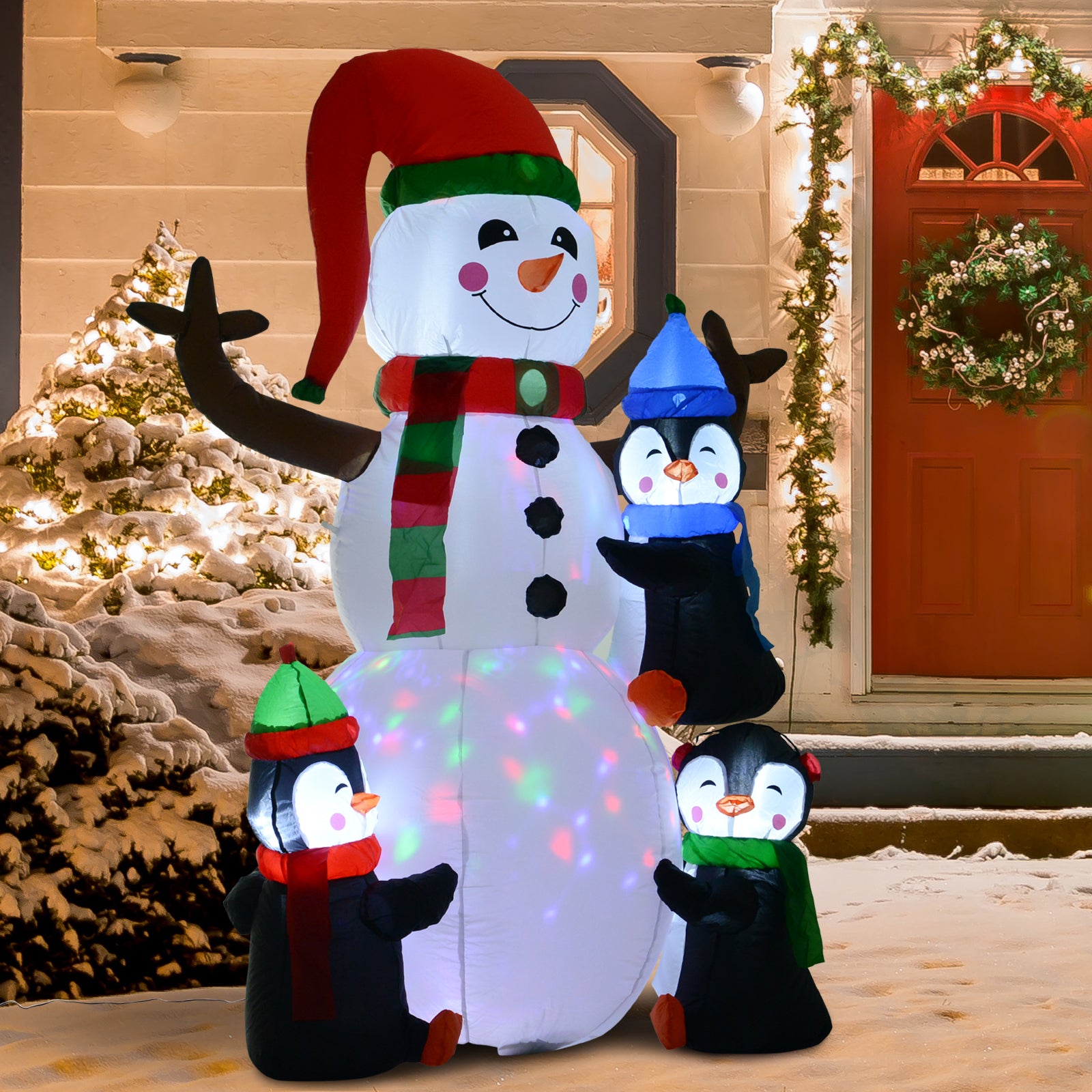 Large inflatable snowman with three penguins in festive winter scene