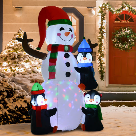 Large inflatable snowman with three penguins in festive winter scene