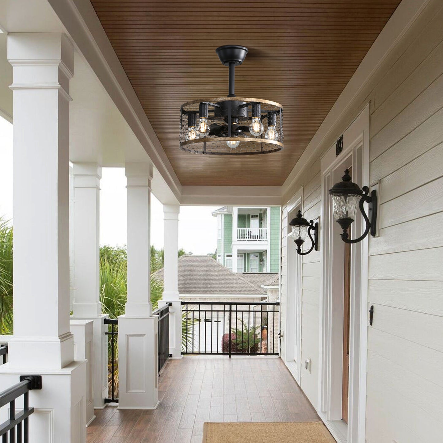 Black industrial cage ceiling fan with wood accents ideal for covered patios