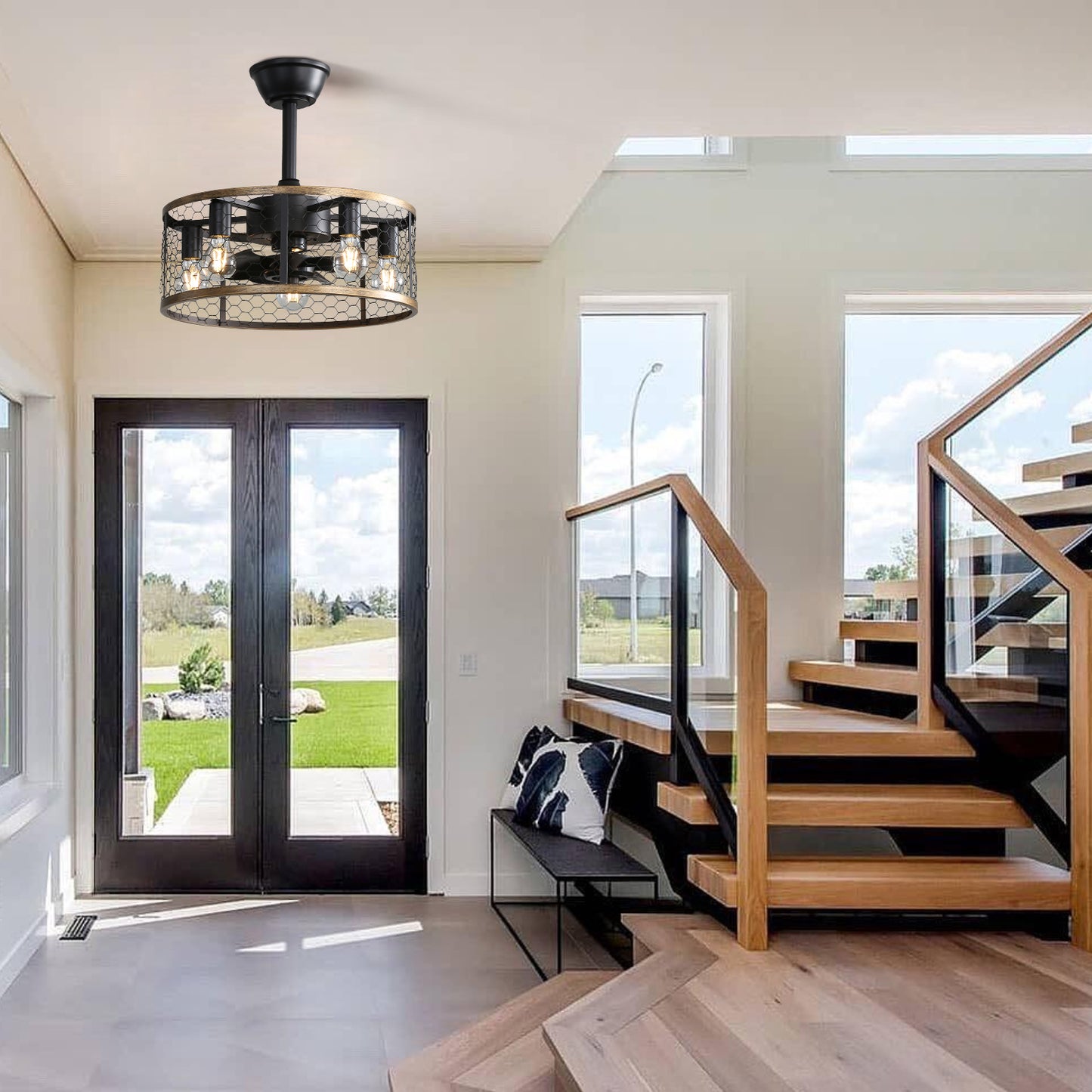 Black farmhouse ceiling fan with caged lights and wood accents