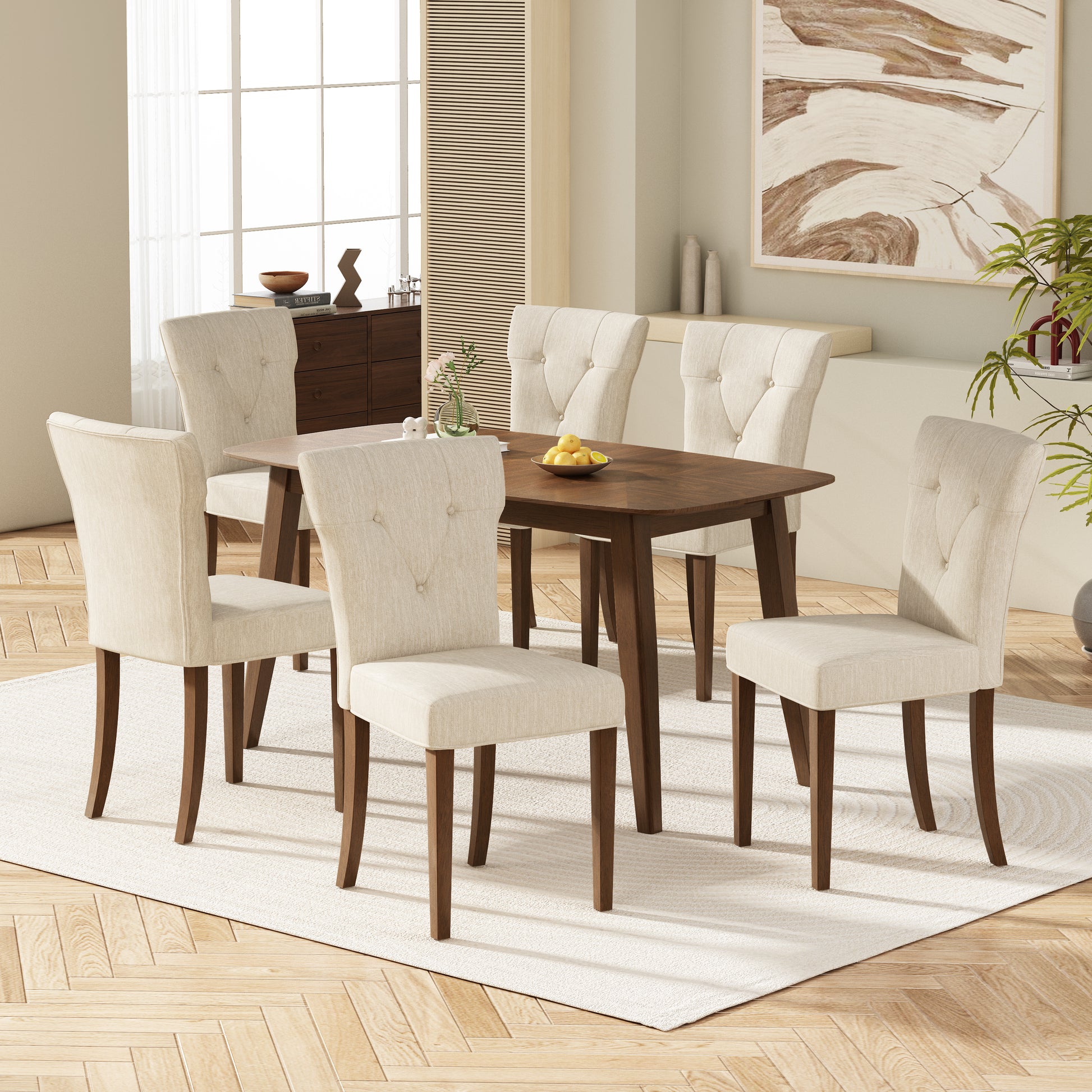 Tufted linen dining chairs with walnut finish legs in a modern dining room setting