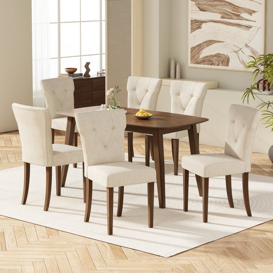 Tufted linen dining chairs with walnut finish legs in a modern dining room setting