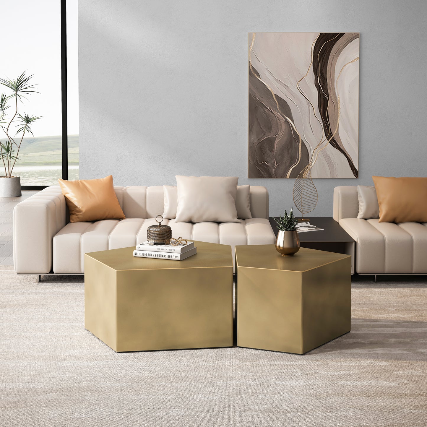 Two hexagonal brushed gold coffee tables with books and decor
