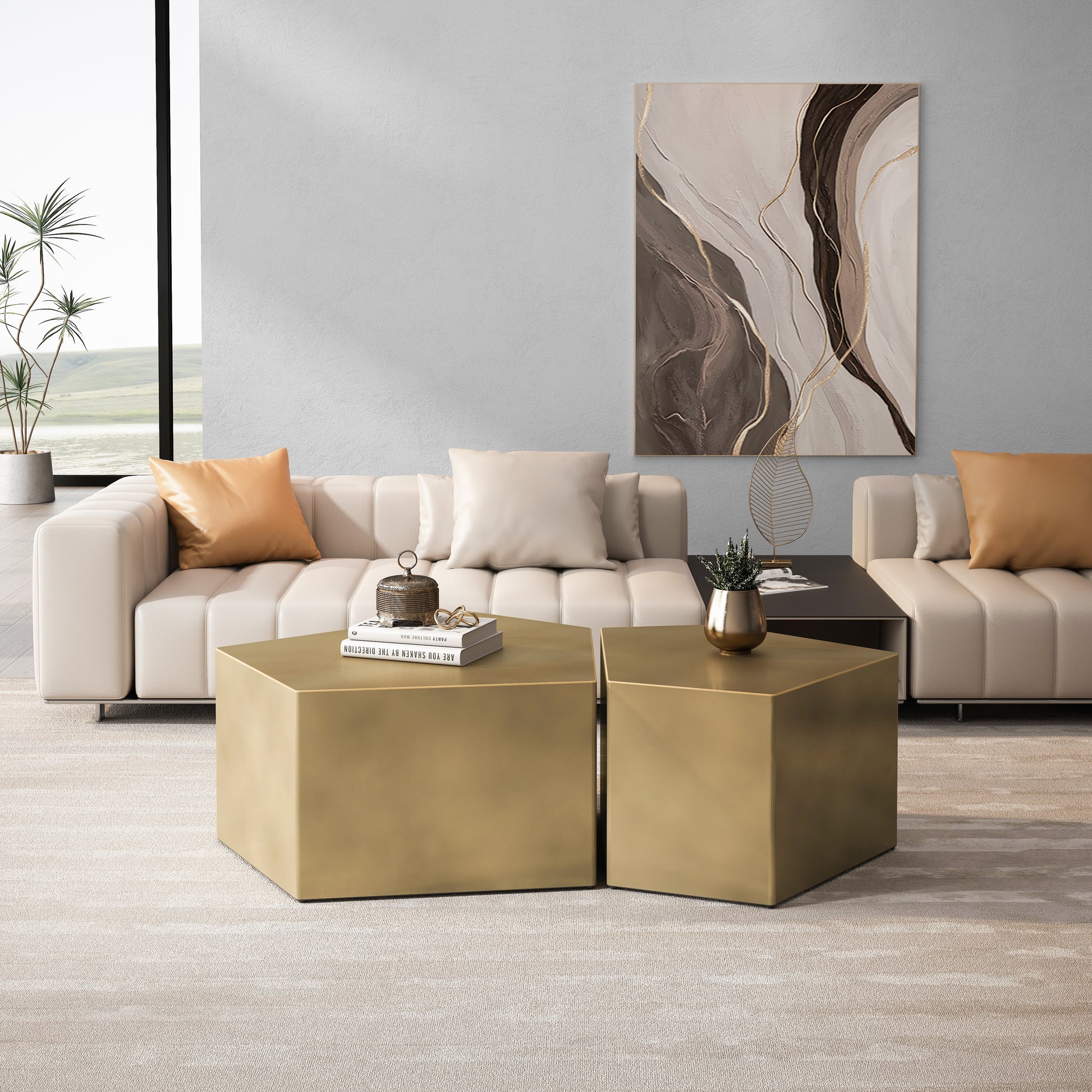 Two hexagonal brushed gold coffee tables with books and decor