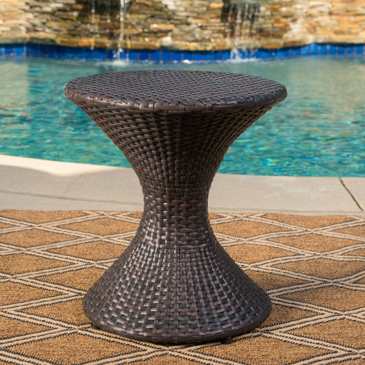 Dark brown wicker hourglass side table with woven texture