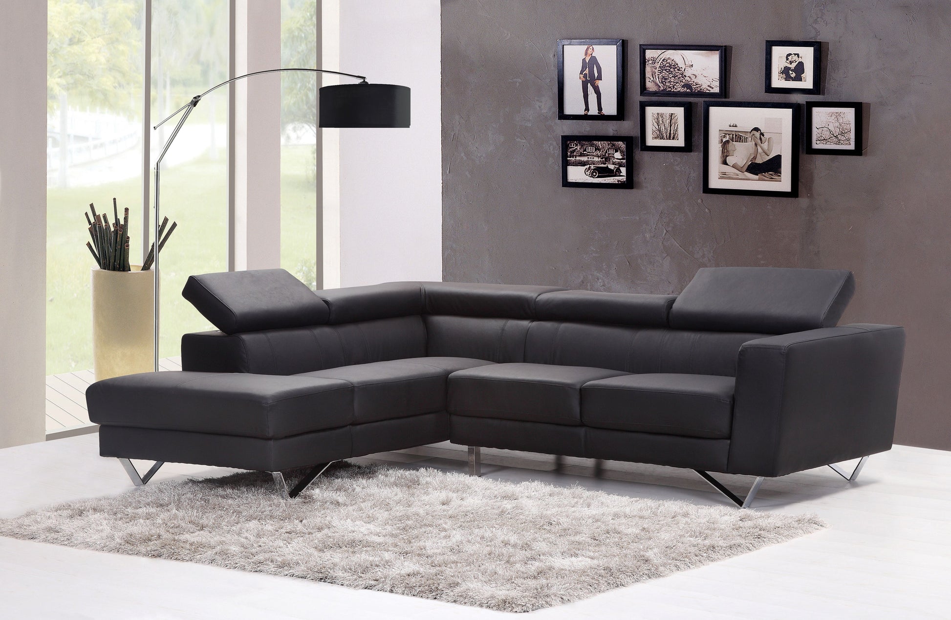 Modern dark grey leather sectional sofa with adjustable headrests and chrome legs